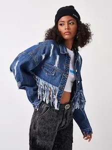 Detail of distressed dark blue denim jacket featuring long fringe and streetwear style
