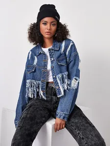 Close-up of distressed dark blue denim jacket featuring long fringe and ripped details