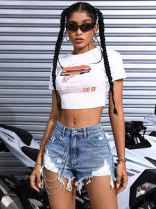Detail of high-waisted light blue denim shorts featuring decorative silver metal chains