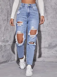 Detailed close-up of distressed light blue high-waisted straight leg jeans with frayed holes