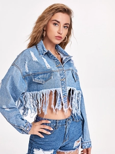Detail showing the heavy frayed edges and long fringe hem on a light blue denim jacket