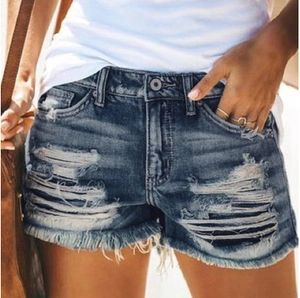 Distressed dark blue denim shorts with ripped holes and frayed fringe hem for women
