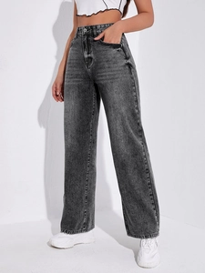 Detailed macro shot of vintage acid wash texture on high-waisted wide-leg denim jeans
