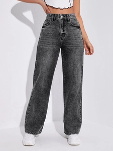 Detail of high-waisted dark grey acid wash wide leg denim jeans with vintage faded texture