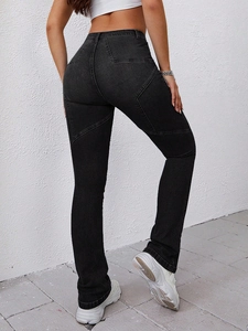 Detail showing high-waisted gray flare jeans with unique star stitching design on back