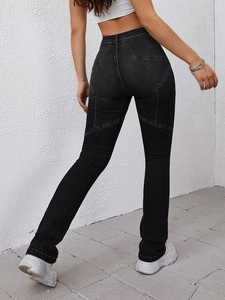 Detail of slim-fit dark grey flare jeans featuring distinctive star-shaped contrast stitching