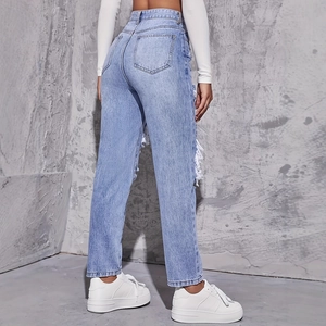 Light blue high waisted straight jeans with side distressed details and street style look