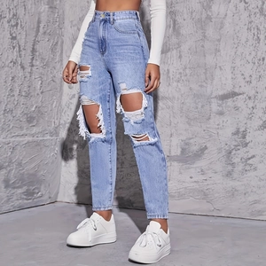 Women's light blue high-waisted distressed denim jeans with large ripped details