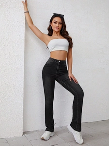 Slim fit high-waisted flared jeans in dark grey denim styled with white crop top and sneakers
