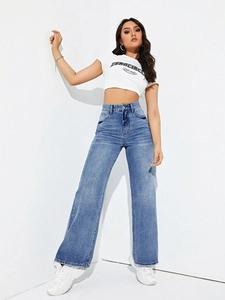 Detail view of high-waisted wide-leg denim jeans with classic five-pocket design and zip fly