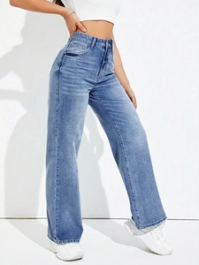 Detail view of high-waisted wide-leg denim jeans in light blue washed vintage style
