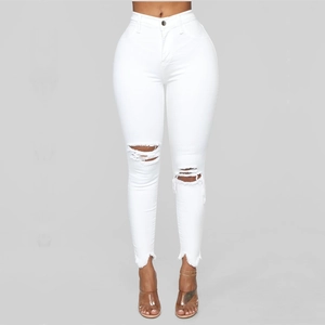 White high waisted ripped skinny jeans with distressed knee details and frayed hems