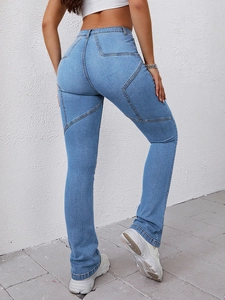 Detail of star-shaped patchwork stitching on the back of light blue flared denim jeans