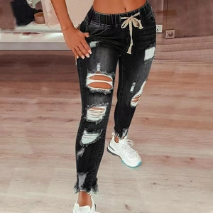 Women's black distressed high-waist jeans with drawstring waist and ripped hole details