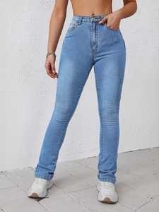 Detailed view of light blue flare jeans with high waist design and yellow contrast stitching