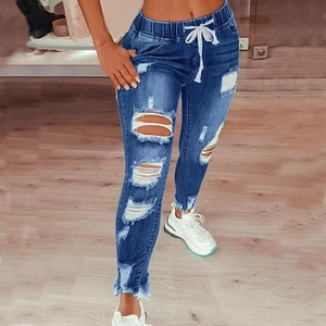 Distressed high-waisted denim jeans with elastic drawstring waist and frayed hem