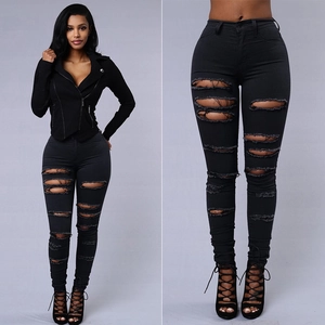 Women's black skinny ripped jeans in high waist style with distressed street fashion details