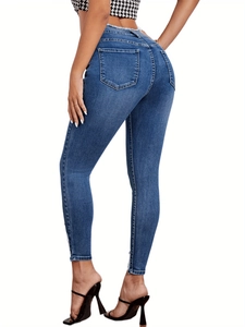 High waist skinny jeans in dark blue denim featuring a raw hem and stretch fit design