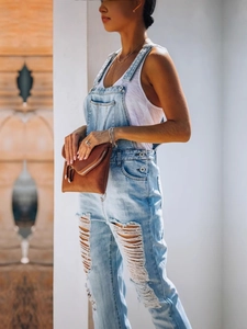 Fashionable light blue ripped denim overalls for women with distressed leg details