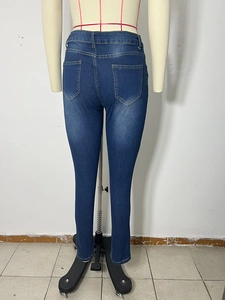 Rear view of slim fit dark blue denim jeans with washed effect and back pocket detail