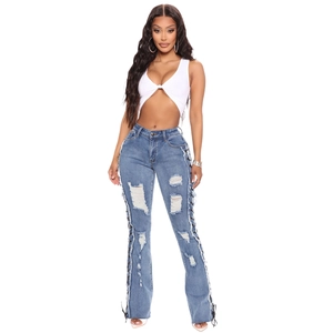 Women's slim fit distressed flare jeans with lace-up side details in washed blue