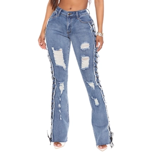 Slim fit high waisted flared blue jeans with side lace-up eyelets and ripped details