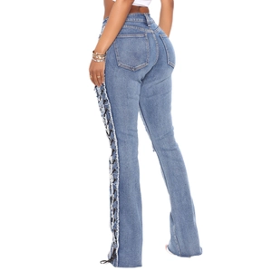 Lace-up side skinny flare jeans with metal eyelets and distressed fringe in blue denim