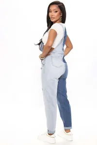 Detail showing two-tone patchwork denim overalls with adjustable straps and rear pockets