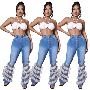 Detail view of high waist denim flare jeans with multi-button closure and mesh patchwork hem