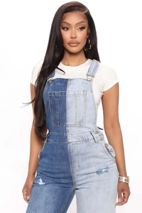 Detail of slim-fit denim overalls with color-block design and adjustable metal buckles