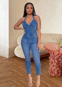 Detail of slim-fit denim halter jumpsuit with metal buttons and classic wash finish