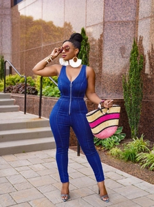 Close-up of slim fit denim jumpsuit with front metal zipper and sexy V-neckline
