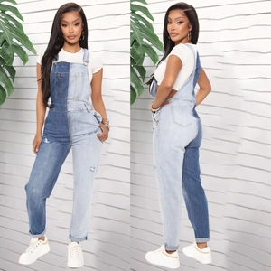 Detail of color-block denim overalls with asymmetric blue wash and distressed knee elements