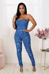 Detailed close-up of dark blue strapless denim jumpsuit with white splatter paint effect