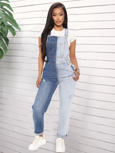 Detail of slim-fit two-tone denim overalls with chest pocket and distressed elements