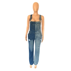 Detail of blue patchwork denim overalls with adjustable straps and chest pocket