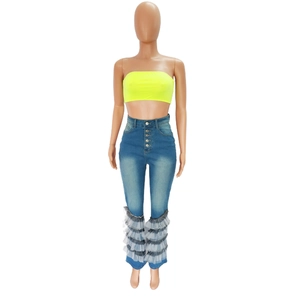 Detail of high waist flared jeans with button closure and layered mesh ruffle hem decoration