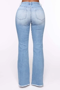 Detail view of high-waisted light blue flared jeans with back pockets and raw hem edges