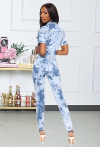 Back view of a tie-dye denim jumpsuit featuring short sleeves and high-waist fit