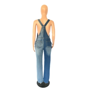 Rear view of two-tone denim overalls with cross straps and contrast blue patchwork design