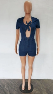 Detail of slim fit dark blue denim romper with hollow lace-up chest and metal buttons