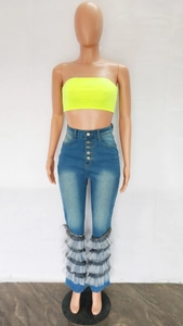 Detail of high waist blue denim flare jeans with multi-layered black and white mesh ruffles