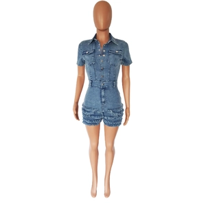Detailed view of frayed fringe hem and blue wash denim on women's slim fit jumpsuit