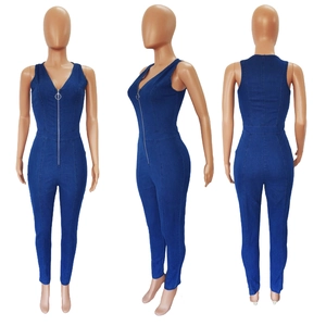 Detailed views of a slim fit navy denim jumpsuit featuring a deep V-neck and metal zipper