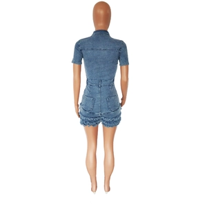 Detail view of denim romper showing back pockets and stylish frayed tassel hemline edges