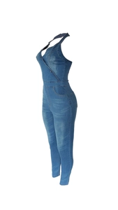 Detail view of denim jumpsuit with halter neck design and stone washed blue texture