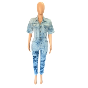 Detail of slim fit denim jumpsuit featuring light blue tie-dye wash and marble texture
