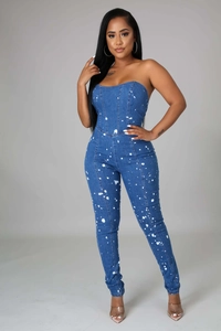 Detail of slim-fit tube denim jumpsuit with artistic white paint splatter print