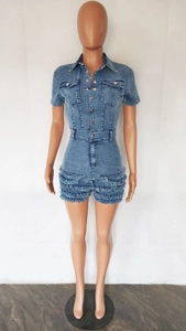 Detailed view of frayed fringe hem and washed light blue denim on a slim romper