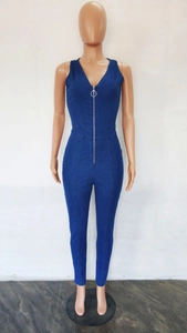 Detail of slim fit dark blue denim jumpsuit with deep V-neck and metal ring zipper